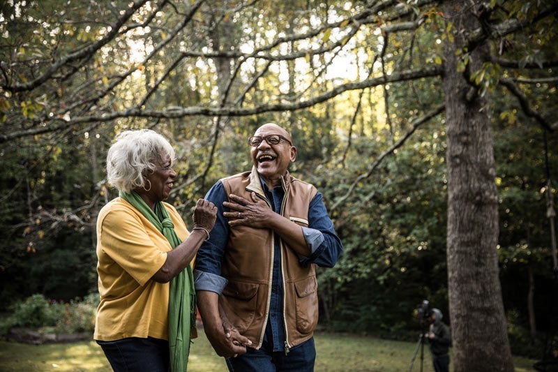 older black man and black woman walking in the woods